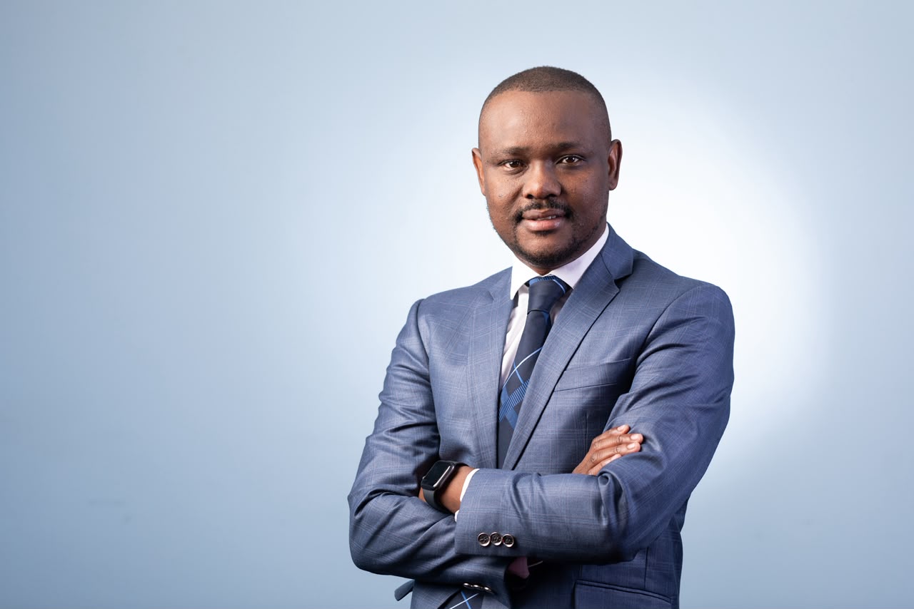 Mothusi Molokomme in a blue suit and tie.